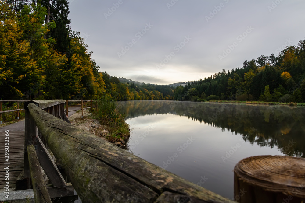 Vltava river with footpath, bridge and autumn foliage Vltava river with footpath, bridge and autumn foliage