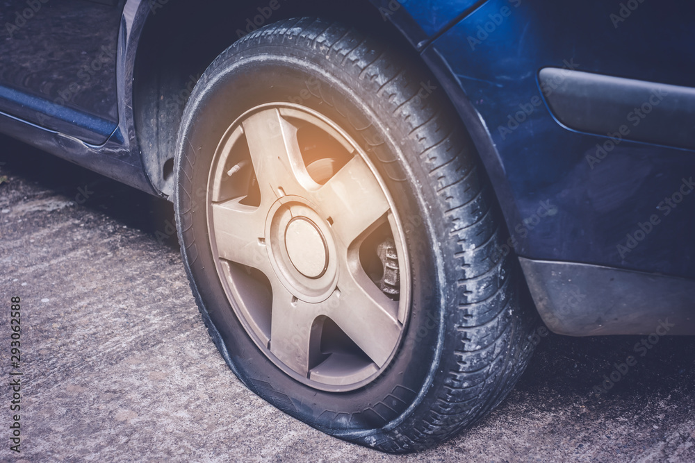 Closeup of a flat tire on car - tire change concept -