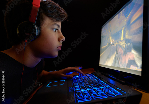 Young Lad playing games on his Laptop