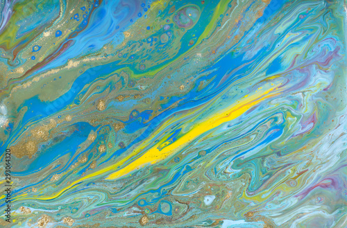 Blue and yellow marble pattern with golden glitter. Abstract liquid background