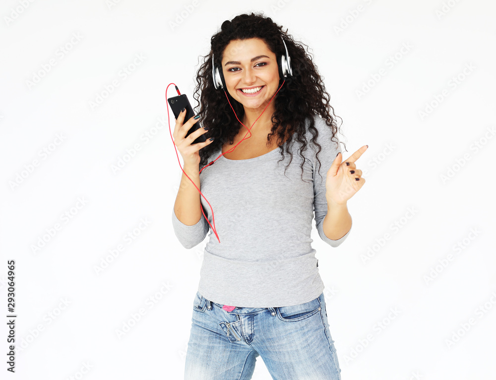 lifestyle, emotion and people concept: young woman at home and listening to music with headphones, over white background lifestyle, emotion and people concept: young woman at home and listening to music with headphones, over white background