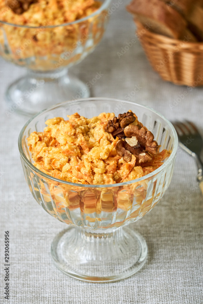 Rice salad with carrots, cheese and walnuts in a glass bowl Rice salad with carrots, cheese and walnuts in a glass bowl