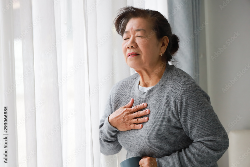 Asian senior woman mother sick with heart attact in living room Asian senior woman mother sick with heart attact in living room