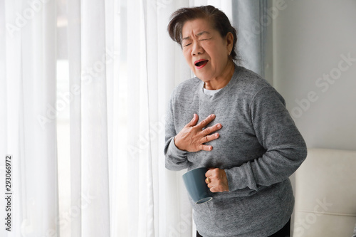 Asian senior woman mother sick with heart attact in living room