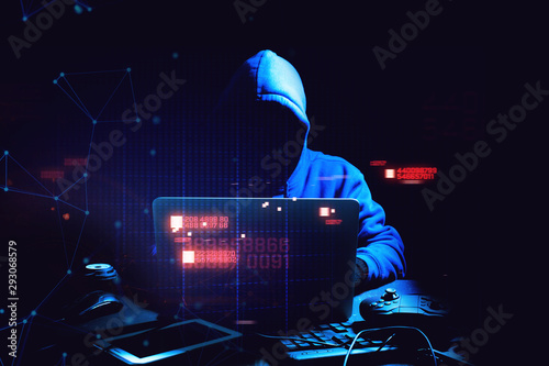 hacker theif  robbery and terrorist man in hoodie is hacking coding an computer laptop to attack data server network system online in technology internet security concept, y2k scifi cyberpunk theme