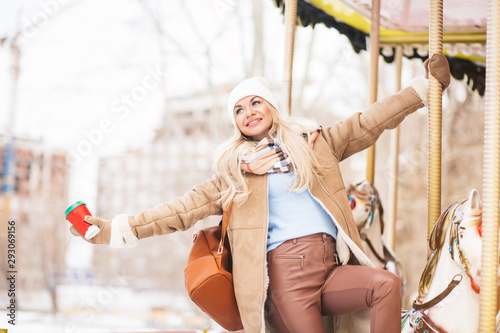 Outdoor photo of happy girl in amusement park in winter