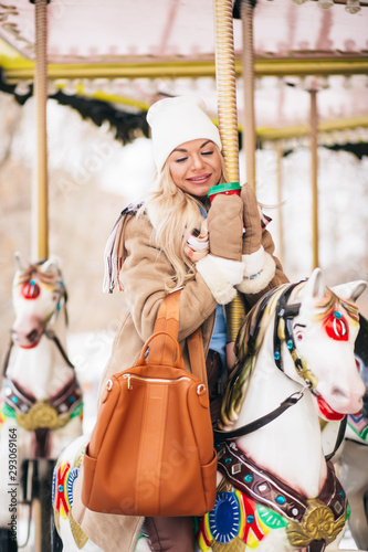 Outdoor photo of happy girl in amusement park in winter
