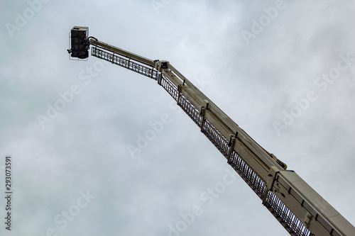telescopic lift of fire truck on sky background
