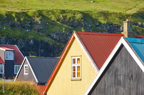 Traditional feroe islands village with colored rooftops and green landscape photo