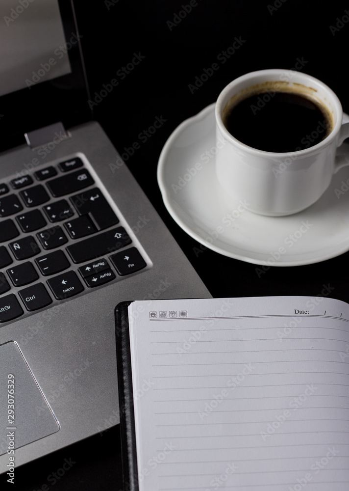 Office desk table with laptop, cup of coffee and other supplies. With copy space Office desk table with laptop, cup of coffee and other supplies. With copy space