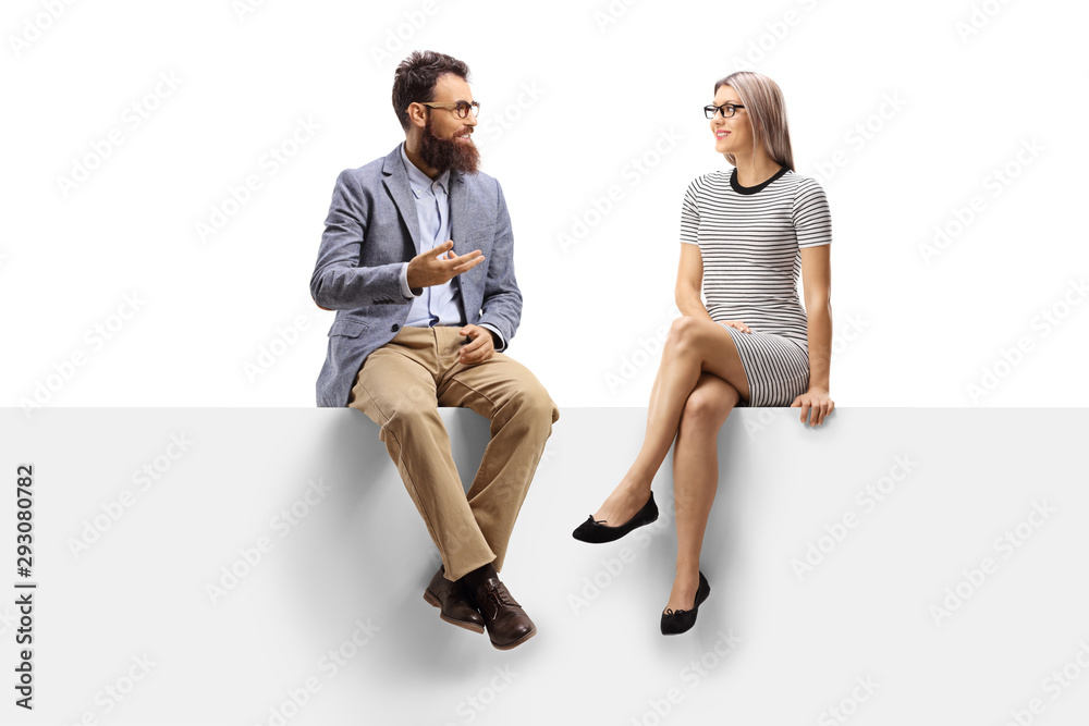 Bearded man talking to a blond woman seated on a panel Bearded man talking to a blond woman seated on a panel