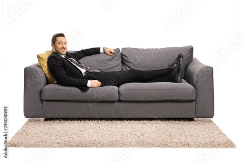 Businessman resting on a sofa after work