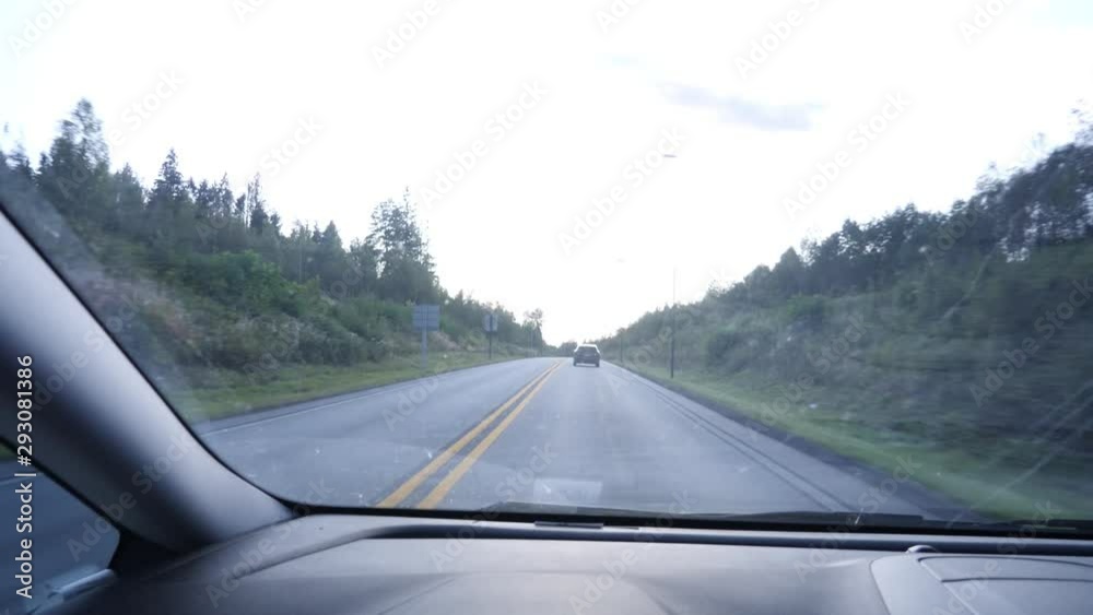 Driving through a tunnel to see the light and forest beyond - car point of view Driving through a tunnel to see the light and forest beyond - car point of view