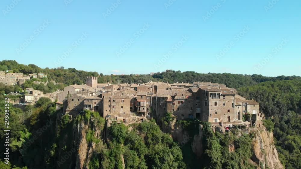 AERIAL TRUCK RIGHT: Drone flying around Calcata Vecchia, a typical Italian medieval town standing on top of a mountain, an ancient community of thriving artists, the grooviest village in Italy AERIAL TRUCK RIGHT: Drone flying around Calcata Vecchia, a typical Italian medieval town standing on top of a mountain, an ancient community of thriving artists, the grooviest village in Italy