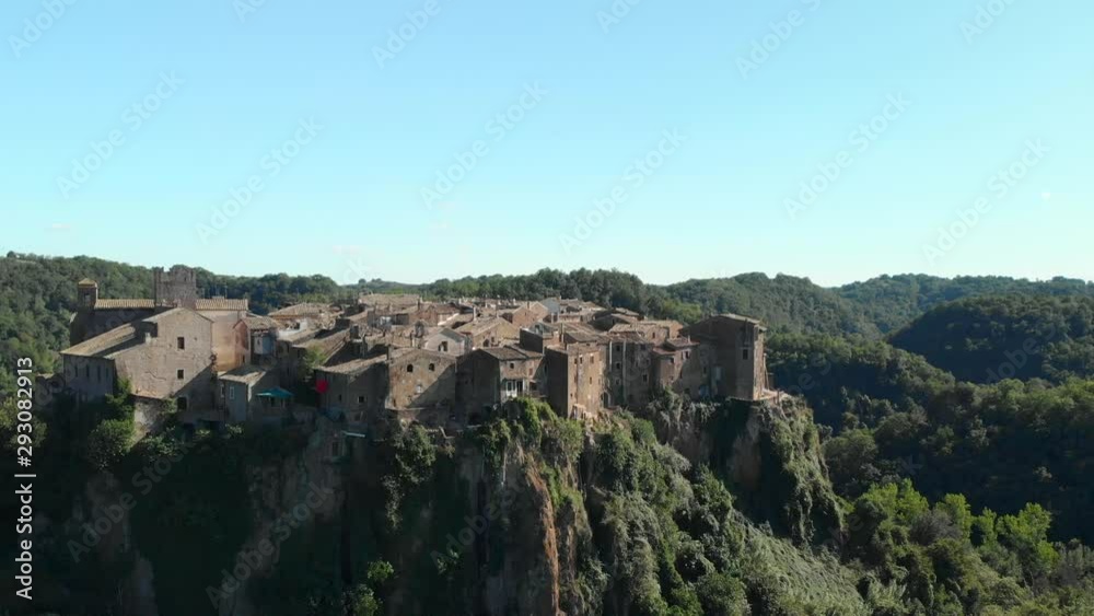 AERIAL TRUCK LEFT: Drone flying around Calcata Vecchia, a typical Italian medieval town standing on top of a mountain, an ancient community of thriving artists, the grooviest village in Italy AERIAL TRUCK LEFT: Drone flying around Calcata Vecchia, a typical Italian medieval town standing on top of a mountain, an ancient community of thriving artists, the grooviest village in Italy