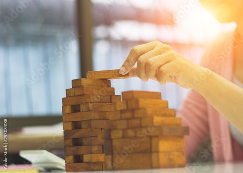 Business women are sitting in the office building construction model to work in the future.