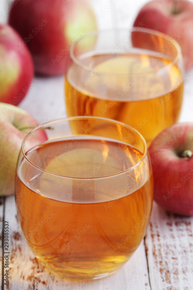 A glass with juice and apples