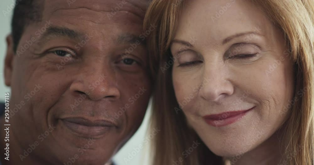 ECU portrait of happily married couple looking at camera and smiling. Close up of African American and Caucasian man and woman happy together. Slow motion 4k handheld ECU portrait of happily married couple looking at camera and smiling. Close up of African American and Caucasian man and woman happy together. Slow motion 4k handheld