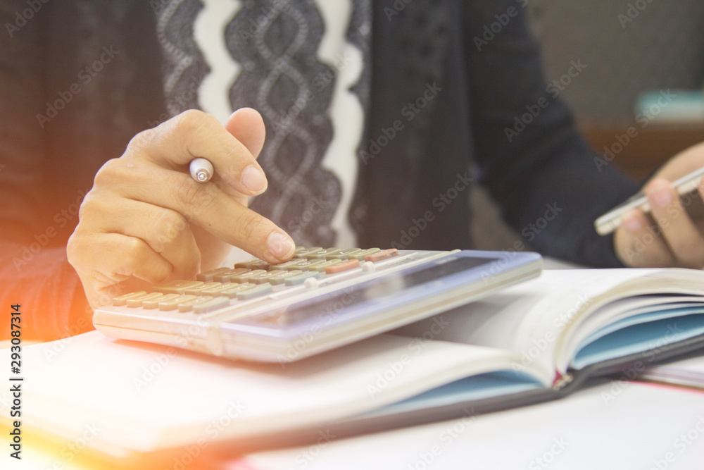 Woman using calculator and calculate online shopping with mobile phone at home office. Woman using calculator and calculate online shopping with mobile phone at home office.