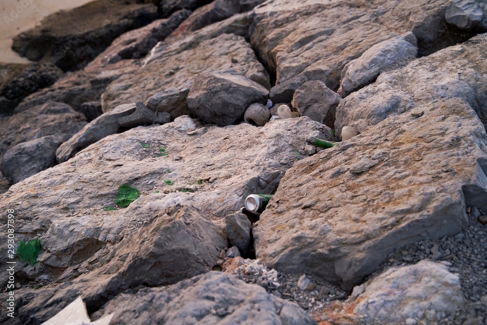 Plastic bottle garbage container floating on dirty ocean sea water, planet pollution report , Plastic bottle under the beach rock Plastic bottle garbage container floating on dirty ocean sea water, planet pollution report , Plastic bottle under the beach rock
