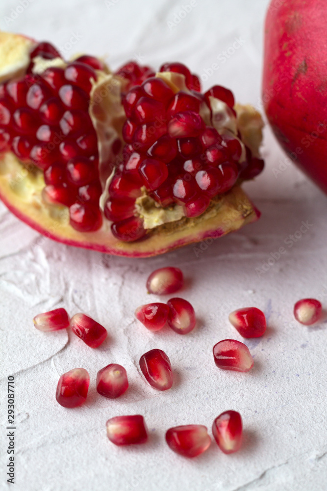 pomegranate with red seeds on a white background pomegranate with red seeds on a white background