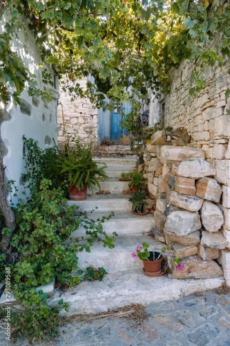 Entrance to a Greek house with a traditional blue door © lostproject
