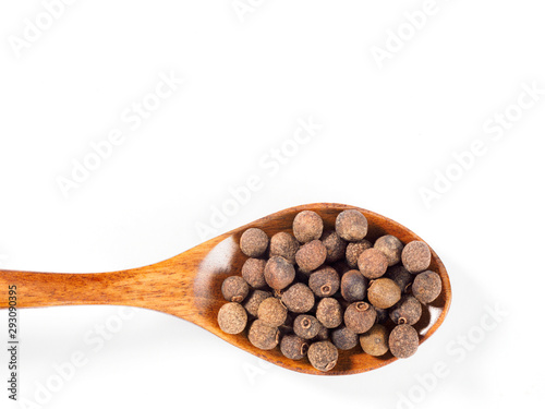 Allspice (Jamaica pepper) in the wooden spoon horizontally on white background