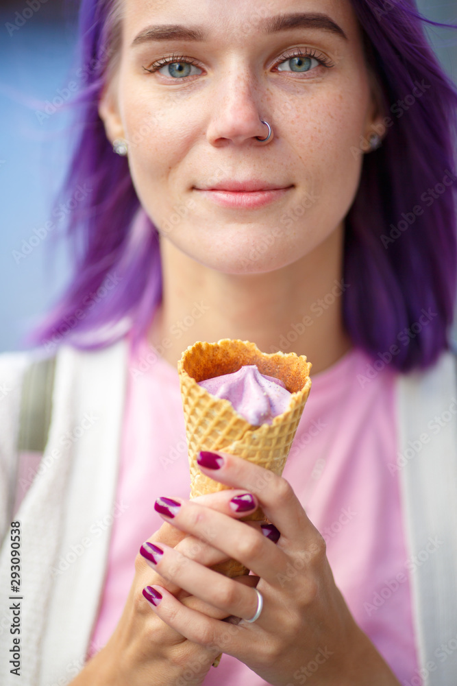 Female with violet hair holding in her hands purple ice cream