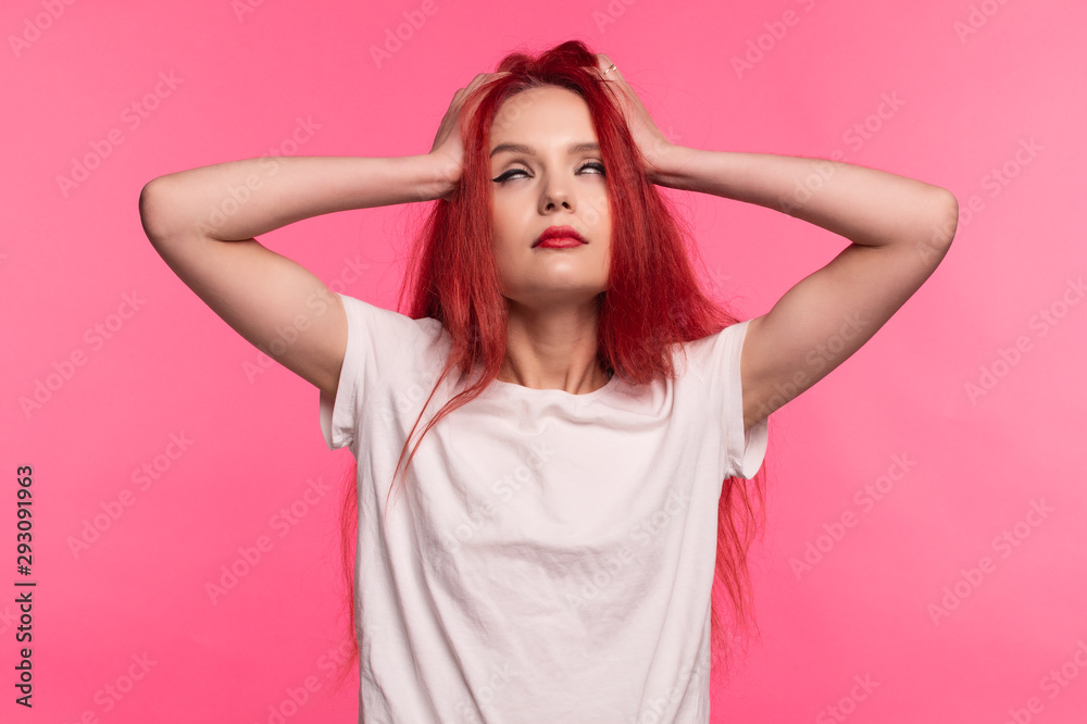 A girl with mental problems clenches her head and rolls her eyes. A girl with mental problems clenches her head and rolls her eyes.