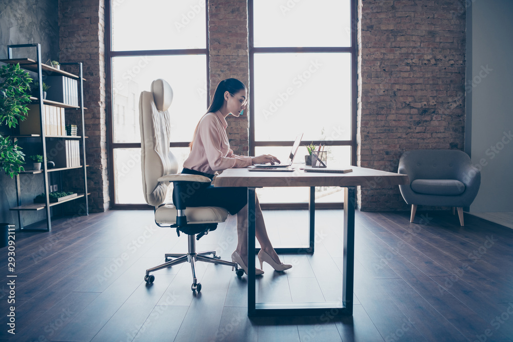 Fototapeta premium Full length body size photo of concentrated serious executive director creating annual plan for her corporation sitting in front of digital device wearing spectacles