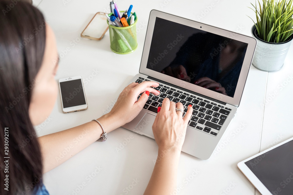 Woman at work or study in office. She do business using her laptop. Copy space Woman at work or study in office. She do business using her laptop. Copy space