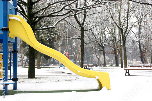 snow covered public childrean playground at winter time photo