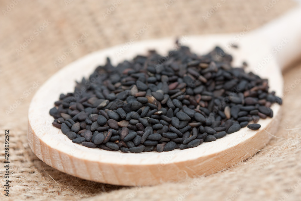 Black sesame seeds in a spoon. Black sesame seeds in a spoon.