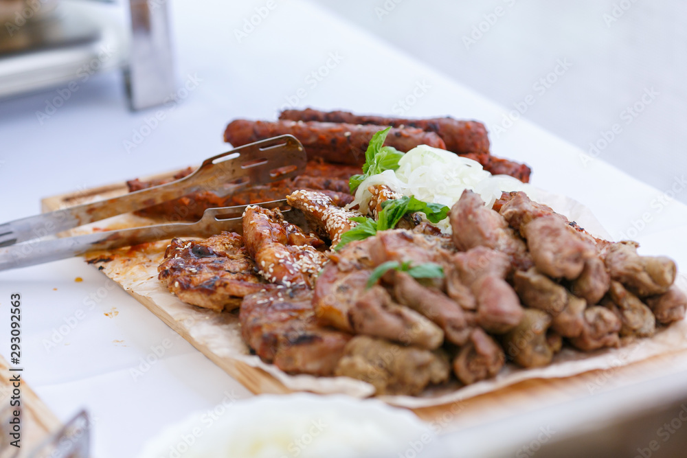 An upper view of fresh assorted barbeque on the wooden cutting board