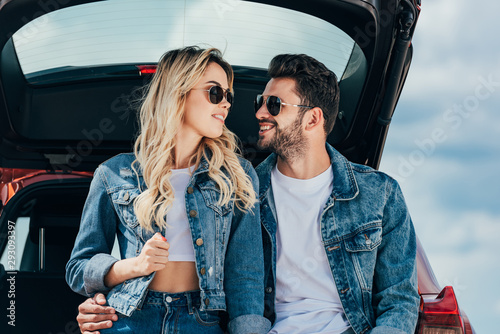 attractive woman and handsome man in denim jackets smiling outside © LIGHTFIELD STUDIOS