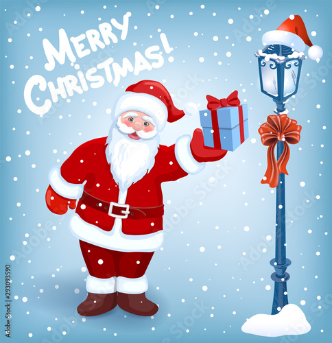 Santa Claus with gift box on background of Christmas snowfall, street lamp and inscription "Merry Christmas"