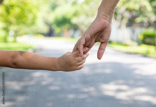 Mother's and child hold hands. Happy in the garden. Mother's love in the hand, on the palm © kowitstockphoto