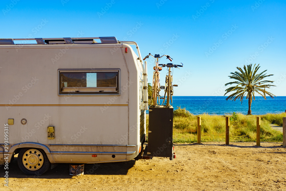 Camper with bicycles on beach, camping on sea Camper with bicycles on beach, camping on sea