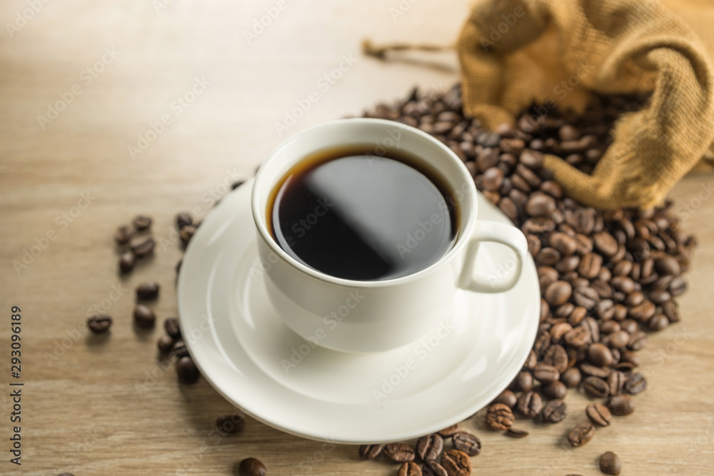Coffee cup and beans on wood background Coffee cup and beans on wood background
