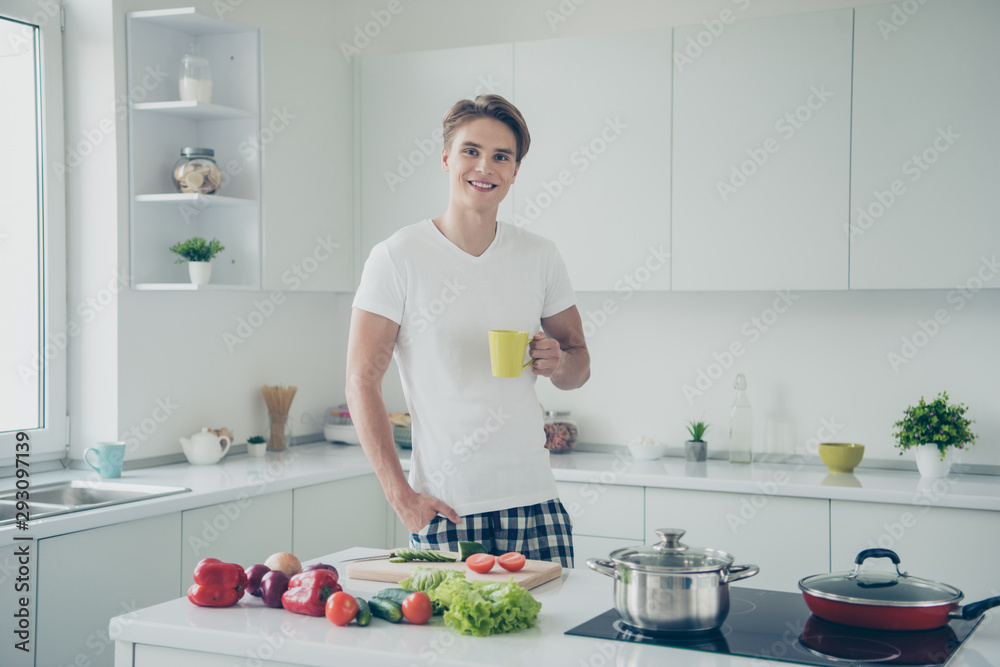 Portrait of his he nice attractive cute cheerful cheery confident guy drinking green tea making dinner lunch at light white modern style interior hotel indoors Portrait of his he nice attractive cute cheerful cheery confident guy drinking green tea making dinner lunch at light white modern style interior hotel indoors