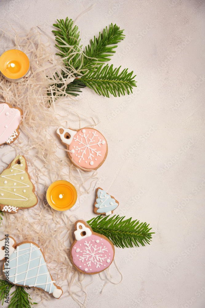 Obraz premium Christmas composition with ginger cookies, candles and spruce branches.