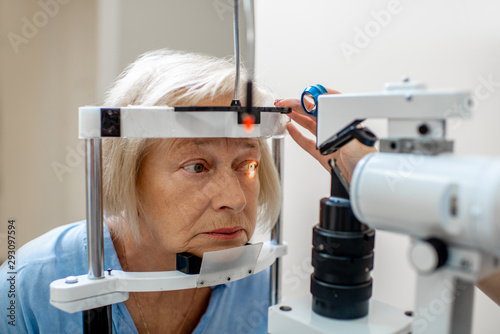 Senior woman during a medical eye examination with microscope in the ophthalmologic office photo