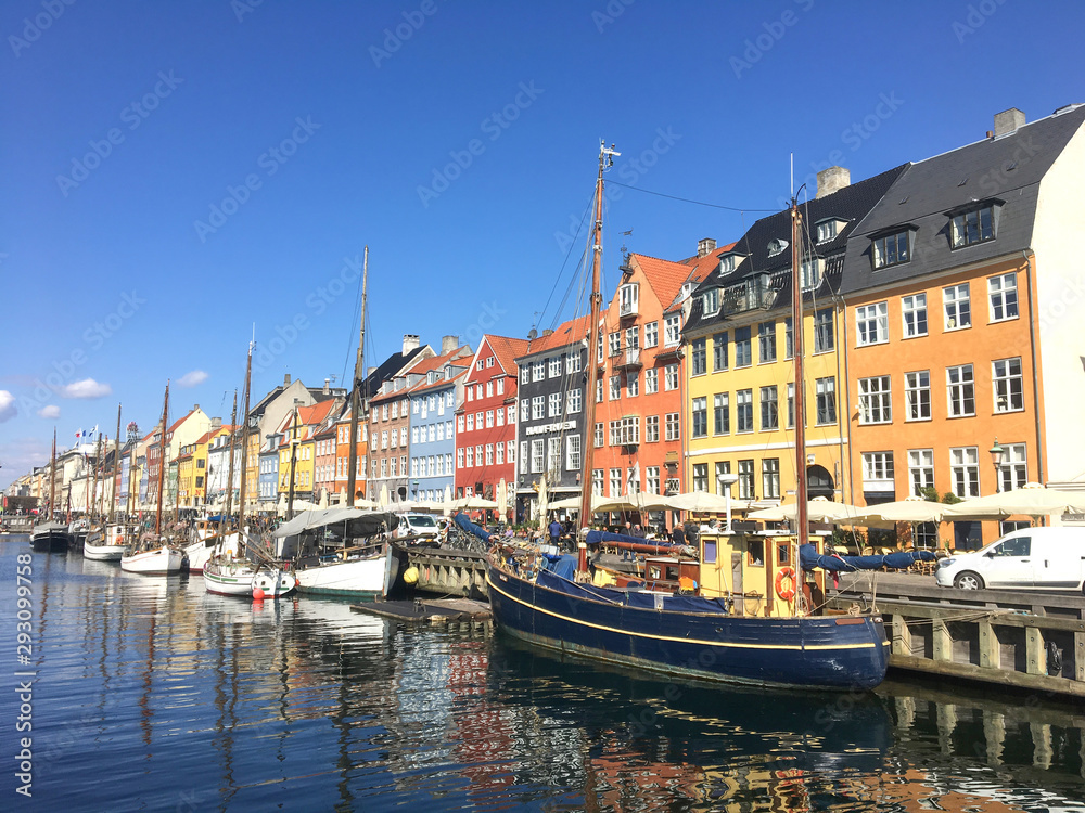 Bright houses along and boats along the canal. Copenhagen.