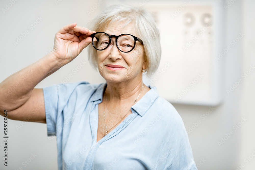 Portrait of a happy senior woman wearing eyeglasses in front of eye