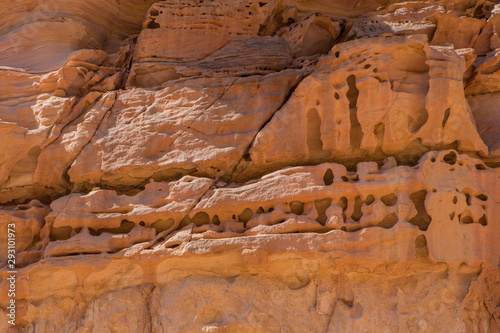 Background based on red sandstone texture. Photos of the walls of the canyon in the Sinai desert