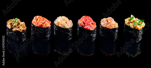 sushi set gunkans on a black background photo