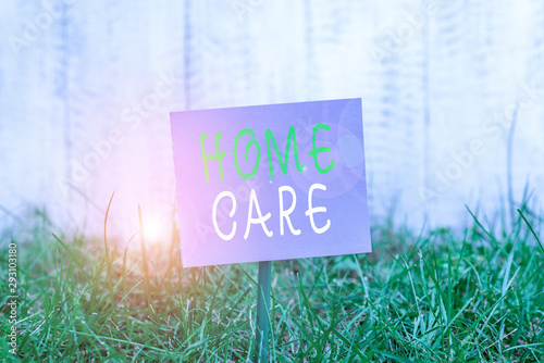 Writing note showing Home Care. Business concept for Place where showing can get the best service of comfort rendered Plain paper attached to stick and placed in the grassy land