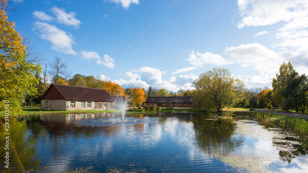 Luznava, Latvia, Autumn landscape with pond and fountain.