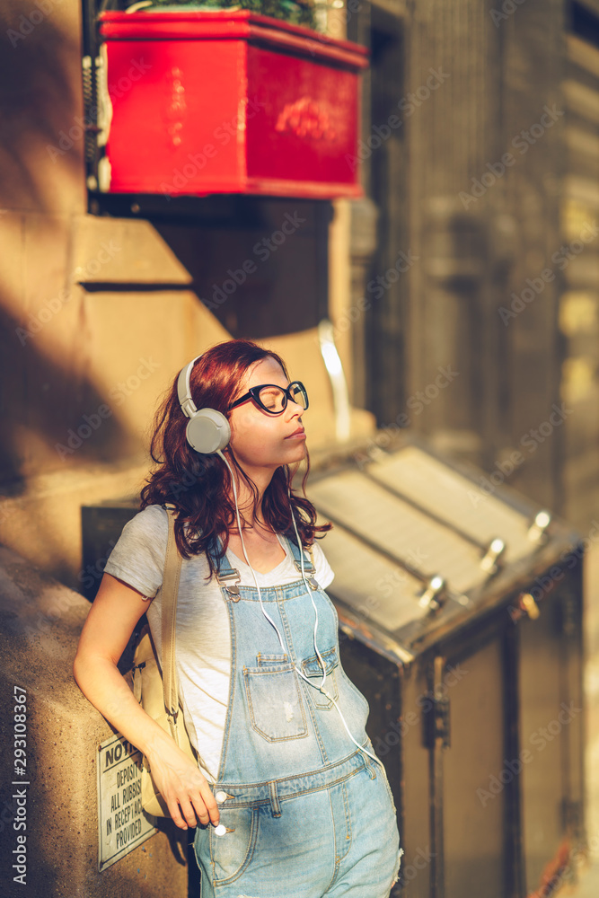 Fototapeta premium Young girl in headphones in New York City