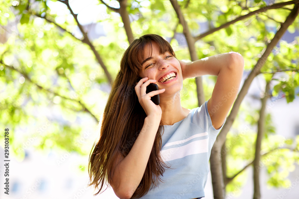 Close up beautiful smiling young woman talking with phone in park Close up beautiful smiling young woman talking with phone in park